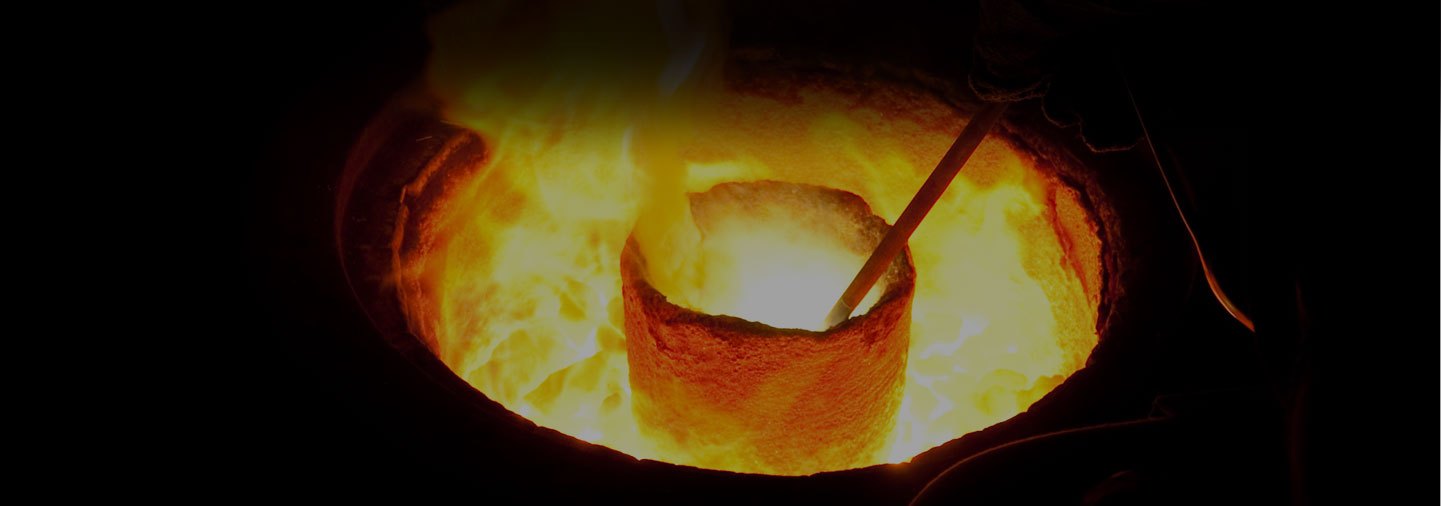 A foundry operator working at a molten metal furnace